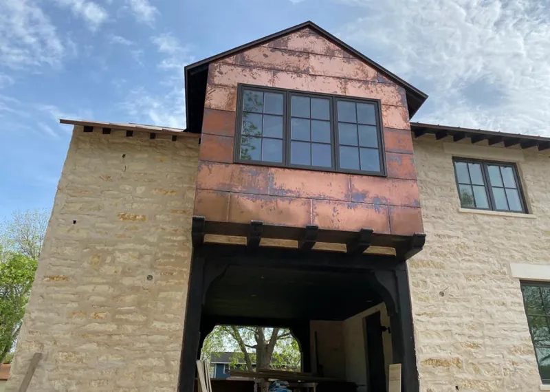 Copper metal panel facade on a stone building for Skylight Installation in Gardena